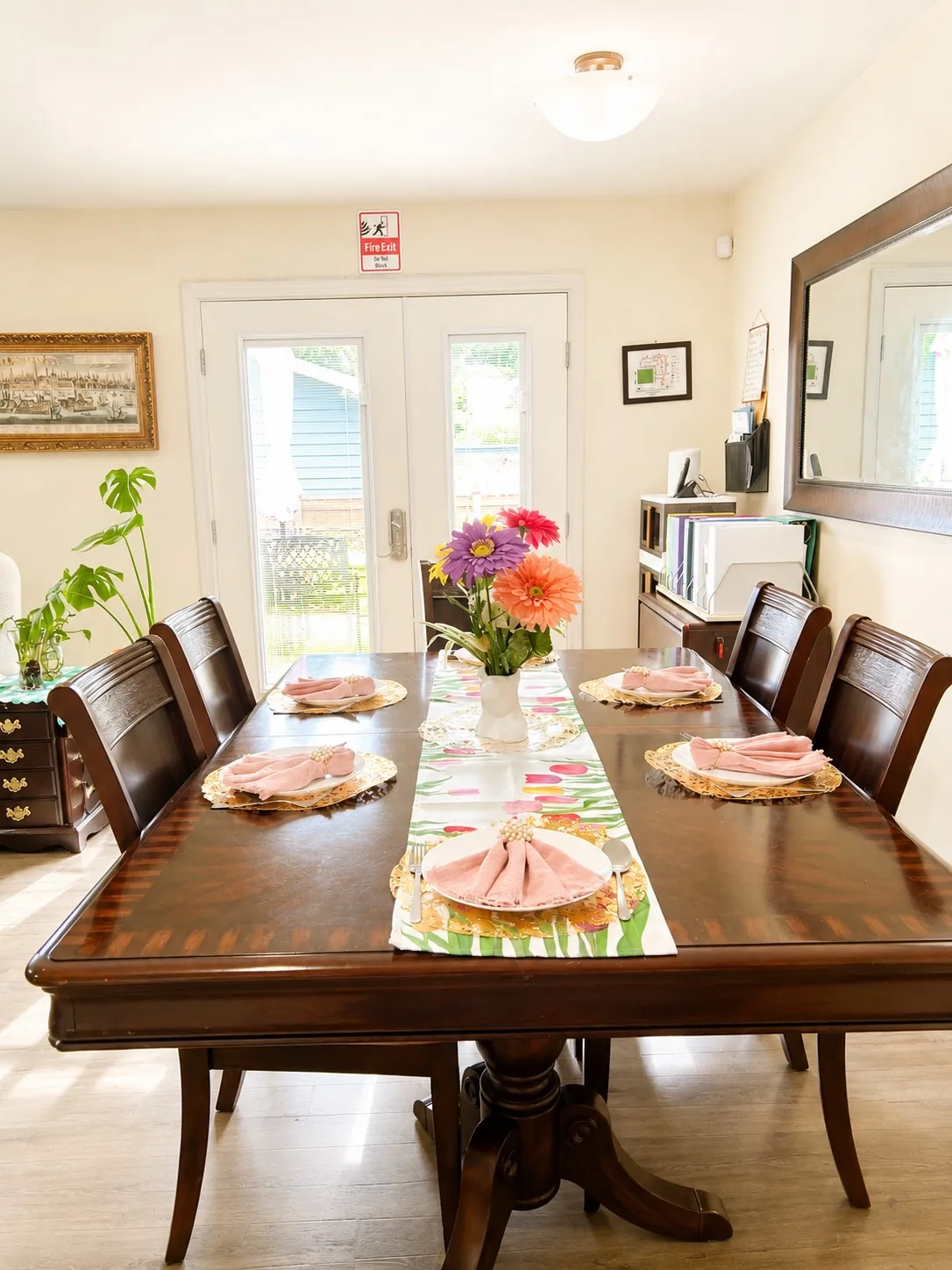 The dining table at A WellCared Adult Family Home, set for a meal with fresh flowers